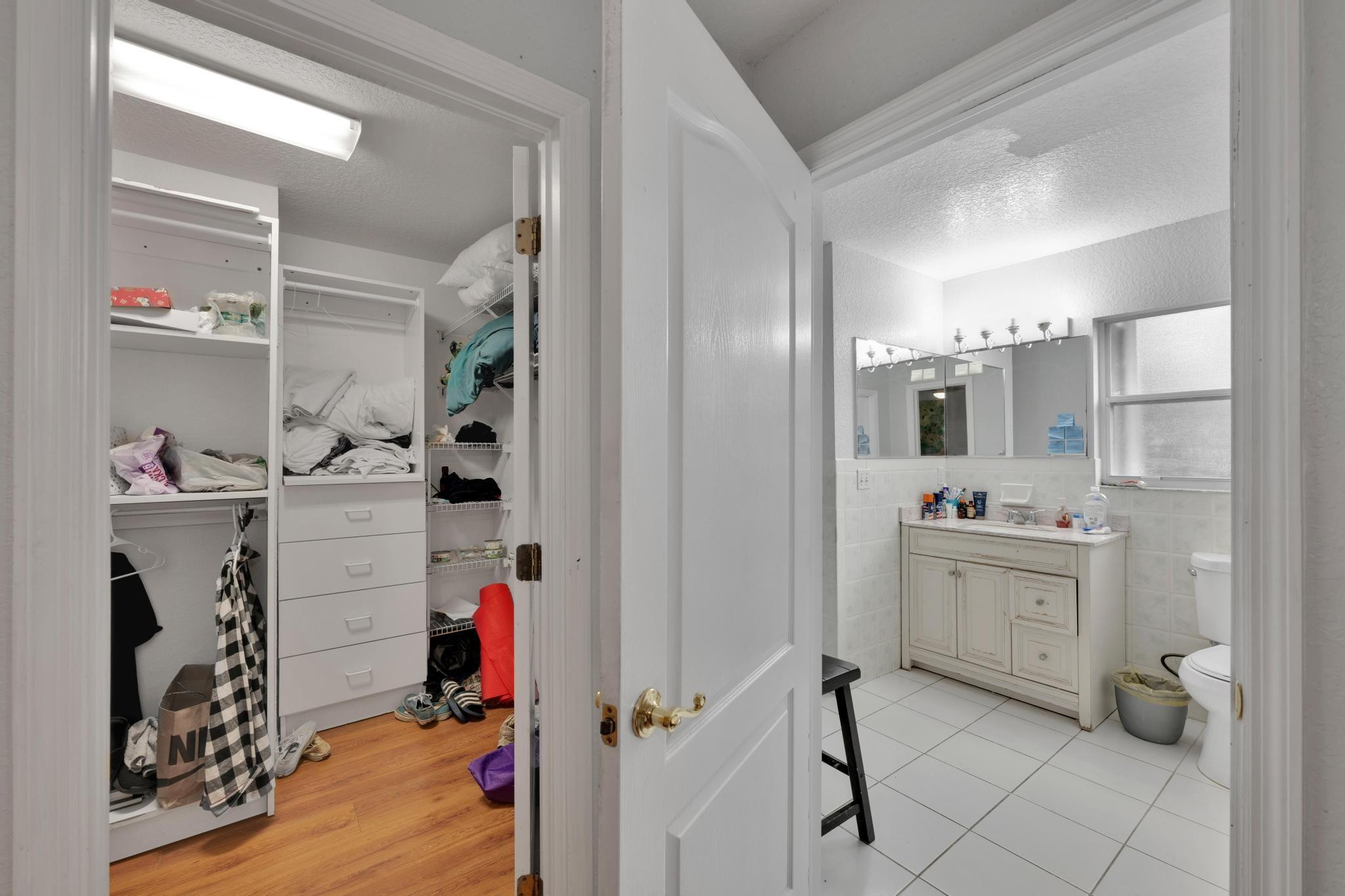 4901 Godfrey Road Parkland, FL 33067 - Photo 45 of 60 a view of walk in closet with clothes and shoes