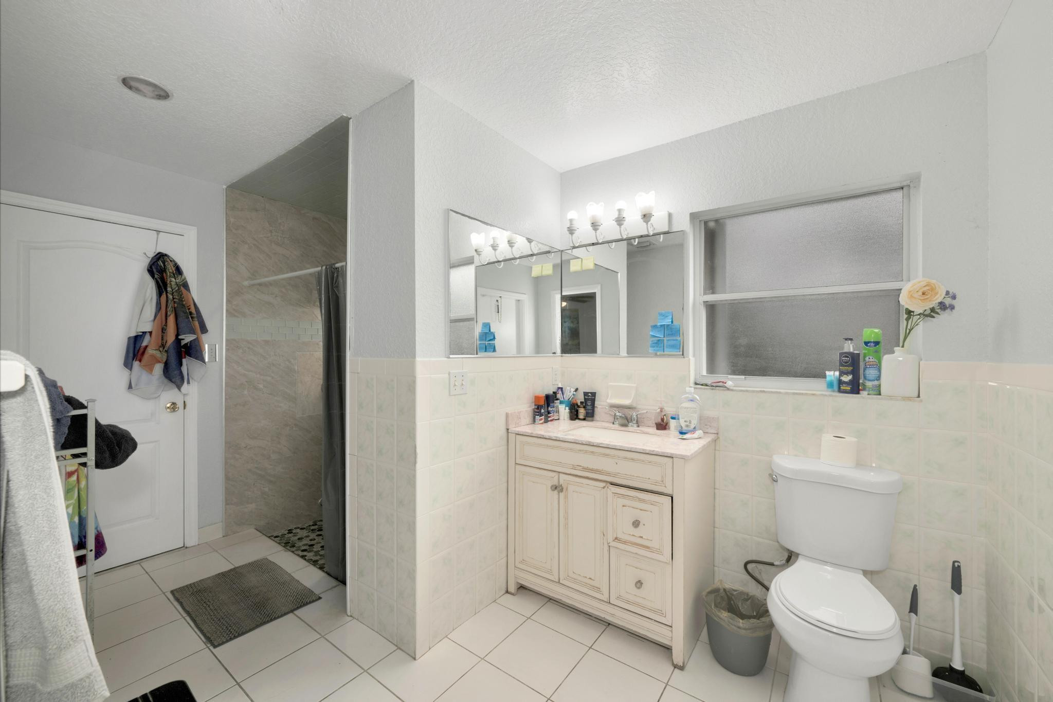 4901 Godfrey Road Parkland, FL 33067 - Photo 47 of 60 a bathroom with a toilet sink and mirror