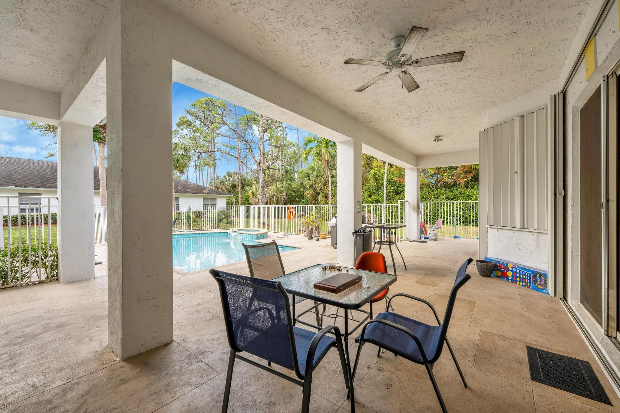 4901 Godfrey Road Parkland, FL 33067 - Photo 51 of 60 a dining room with furniture a chandelier and wooden floor