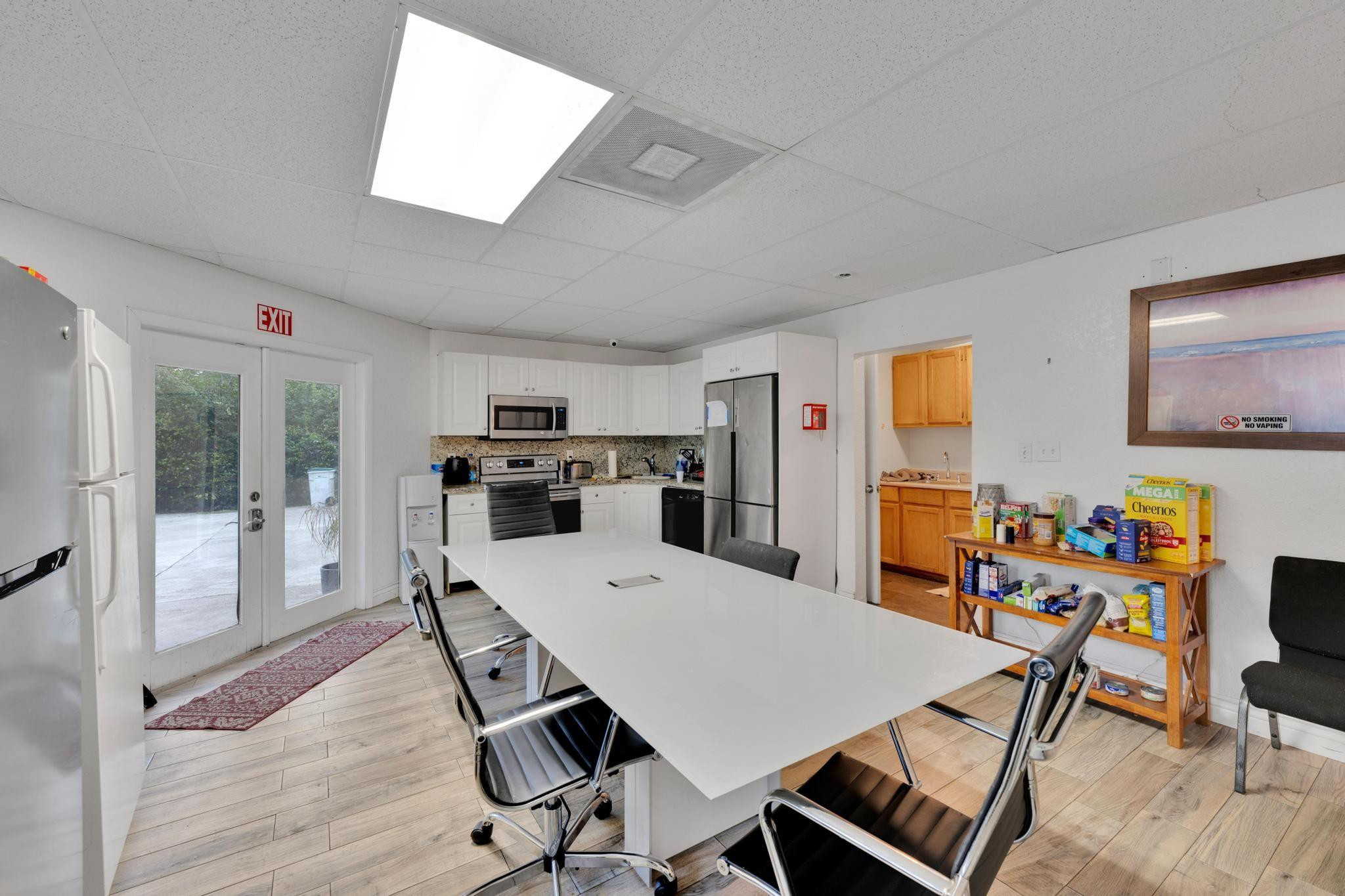 4901 Godfrey Road Parkland, FL 33067 - Photo 54 of 60 a view of a dining room with furniture a kitchen and chandelier