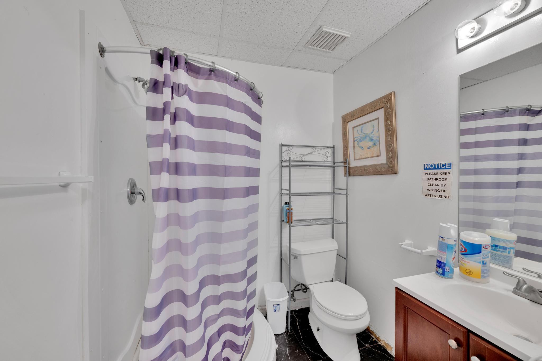 4901 Godfrey Road Parkland, FL 33067 - Photo 55 of 60 a white toilet sitting next to a bathroom sink