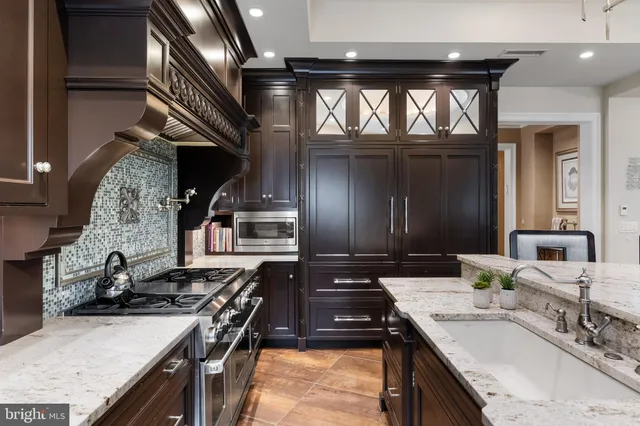 a kitchen with stainless steel appliances a stove sink and cabinets