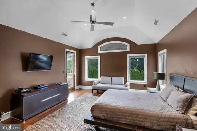 a bedroom with a bed and a large window