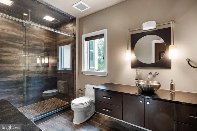 a spacious bathroom with a double vanity sink toilet and shower