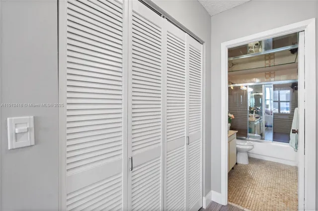 a bathroom with a toilet a sink and shower