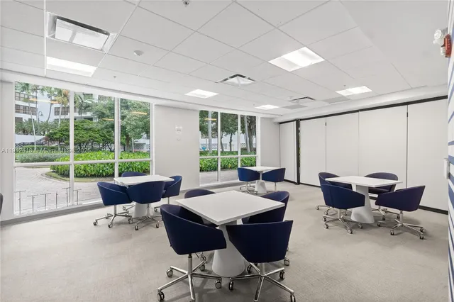 a living room with furniture and floor to ceiling windows