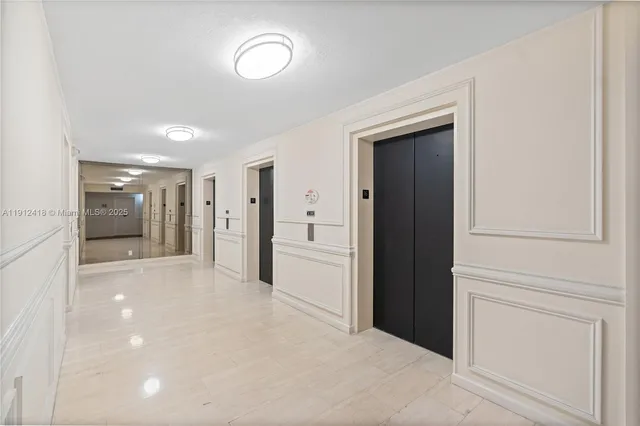 a view of a hallway with some storage and cabinet