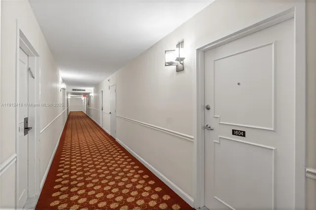 a view of hallway with wooden floor
