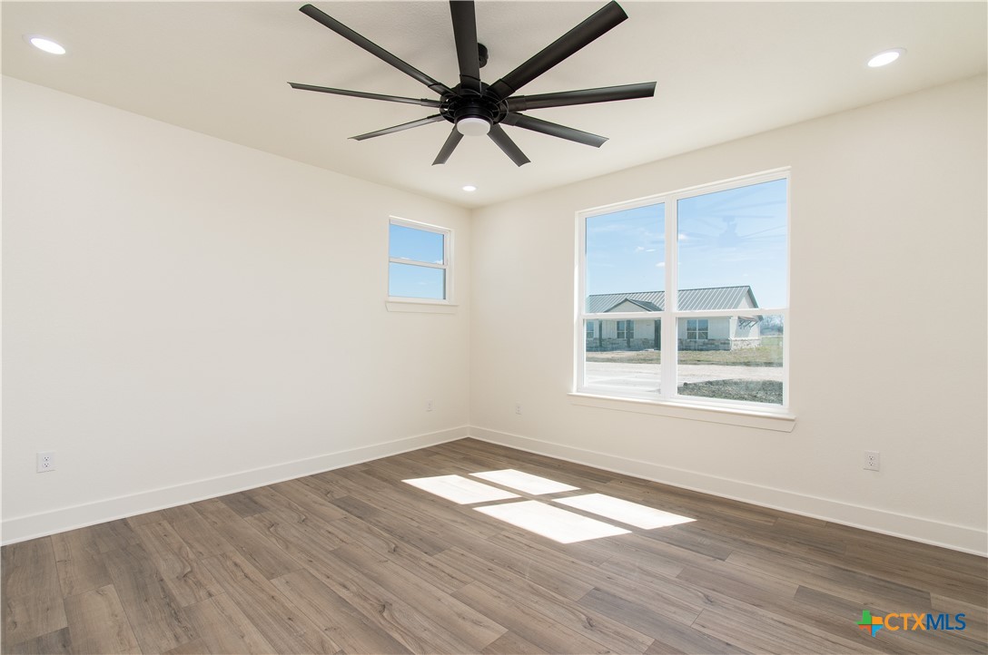 4245 Stringtown Road Temple, TX 76501 - Photo 10 of 25 an empty room with wooden floor and windows