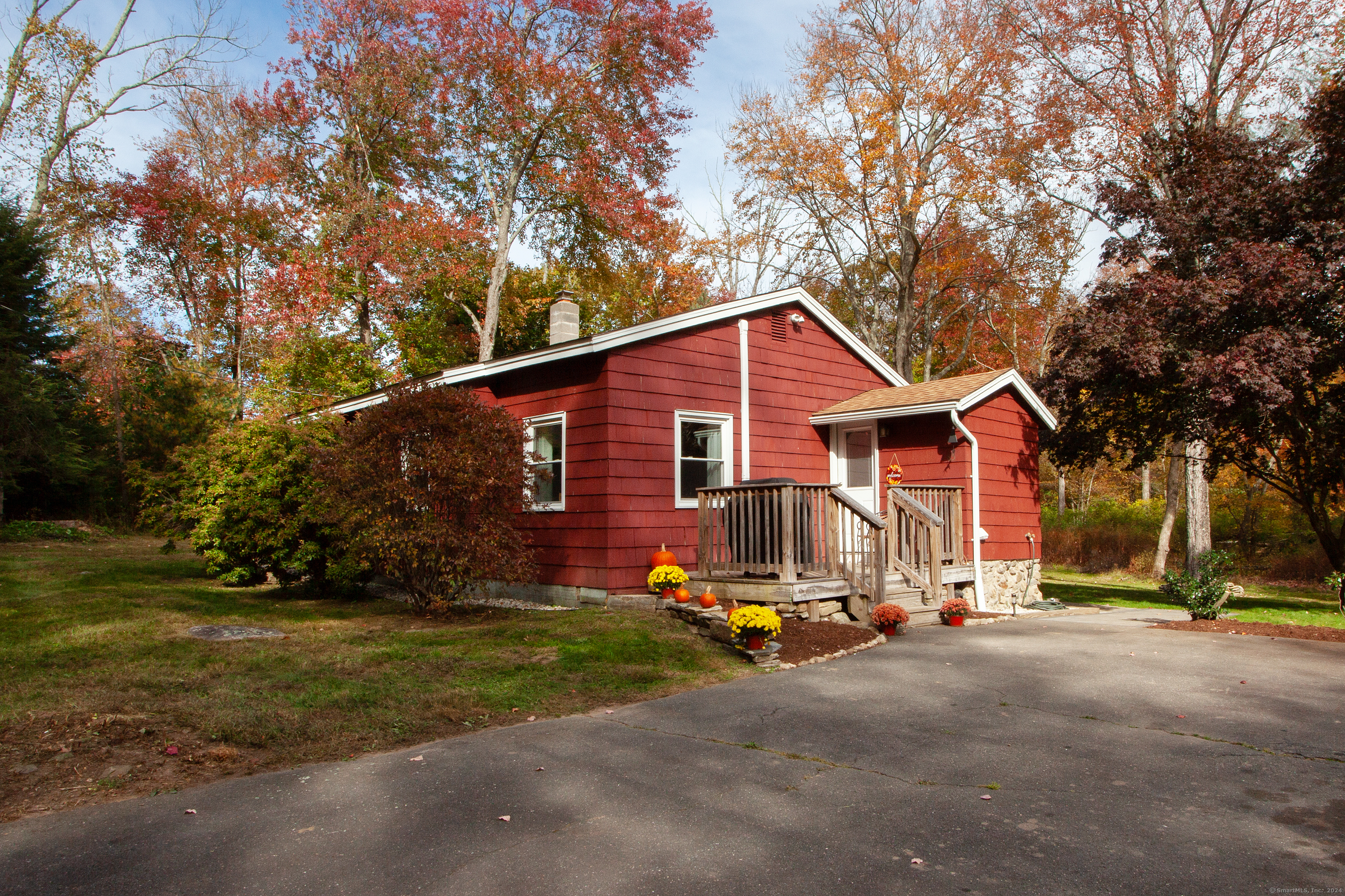 a view of backyard of house with wooden fence and trees