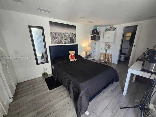 a bedroom with a bed and a flat screen tv