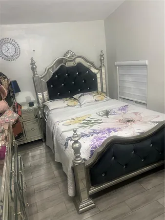 a bedroom with a bed and a mirror