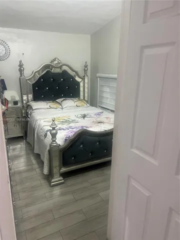 a bedroom with a bed and a closet