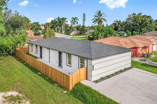 a view of a house with wooden fence