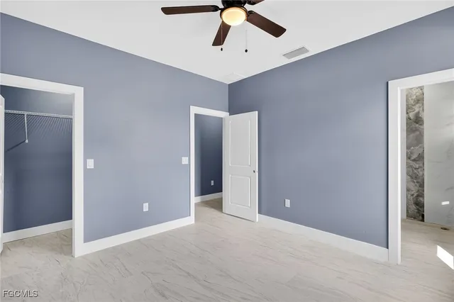 an empty room with closet and entryway