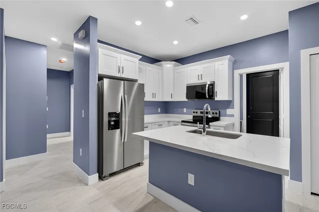 a kitchen with a refrigerator and a sink