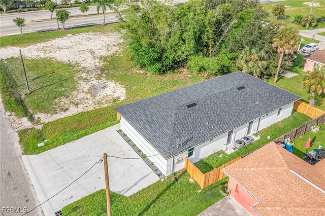 a aerial view of a house with a yard and potted plants