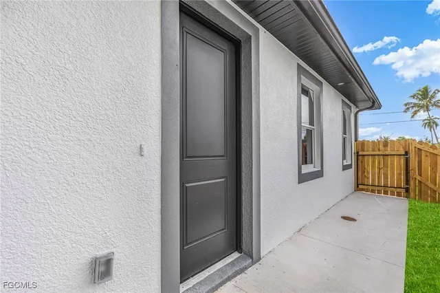 a view of a door and brick walls