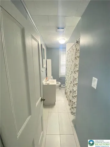 a view of house with wooden deck and furniture