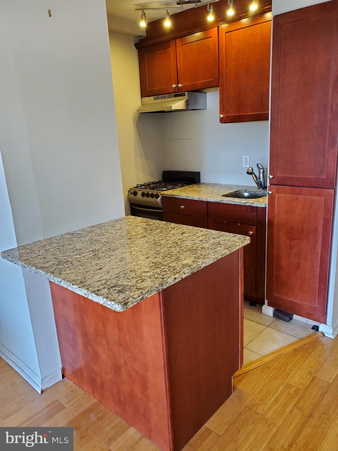 2101-17 Chestnut Street, Unit 1211 Philadelphia, PA 19103 - Photo 5 of 12 a kitchen with stainless steel appliances granite countertop a sink stove and refrigerator