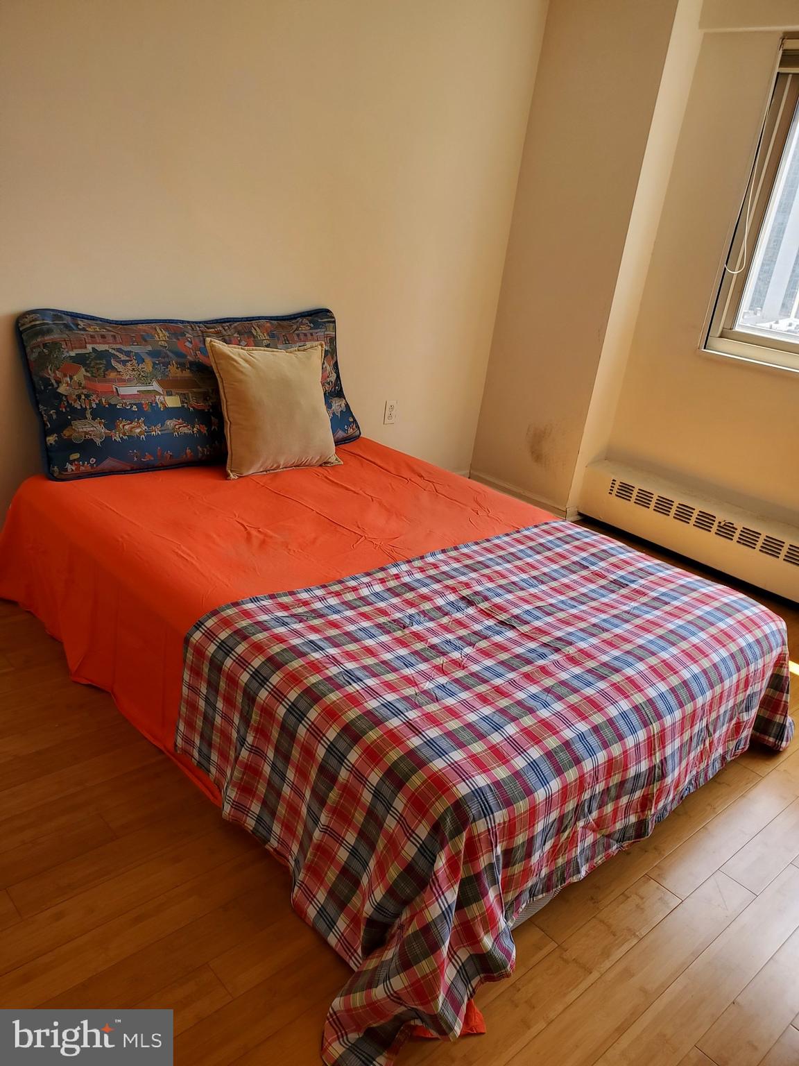 2101-17 Chestnut Street, Unit 1211 Philadelphia, PA 19103 - Photo 7 of 12 a bedroom with a bed and wooden floor