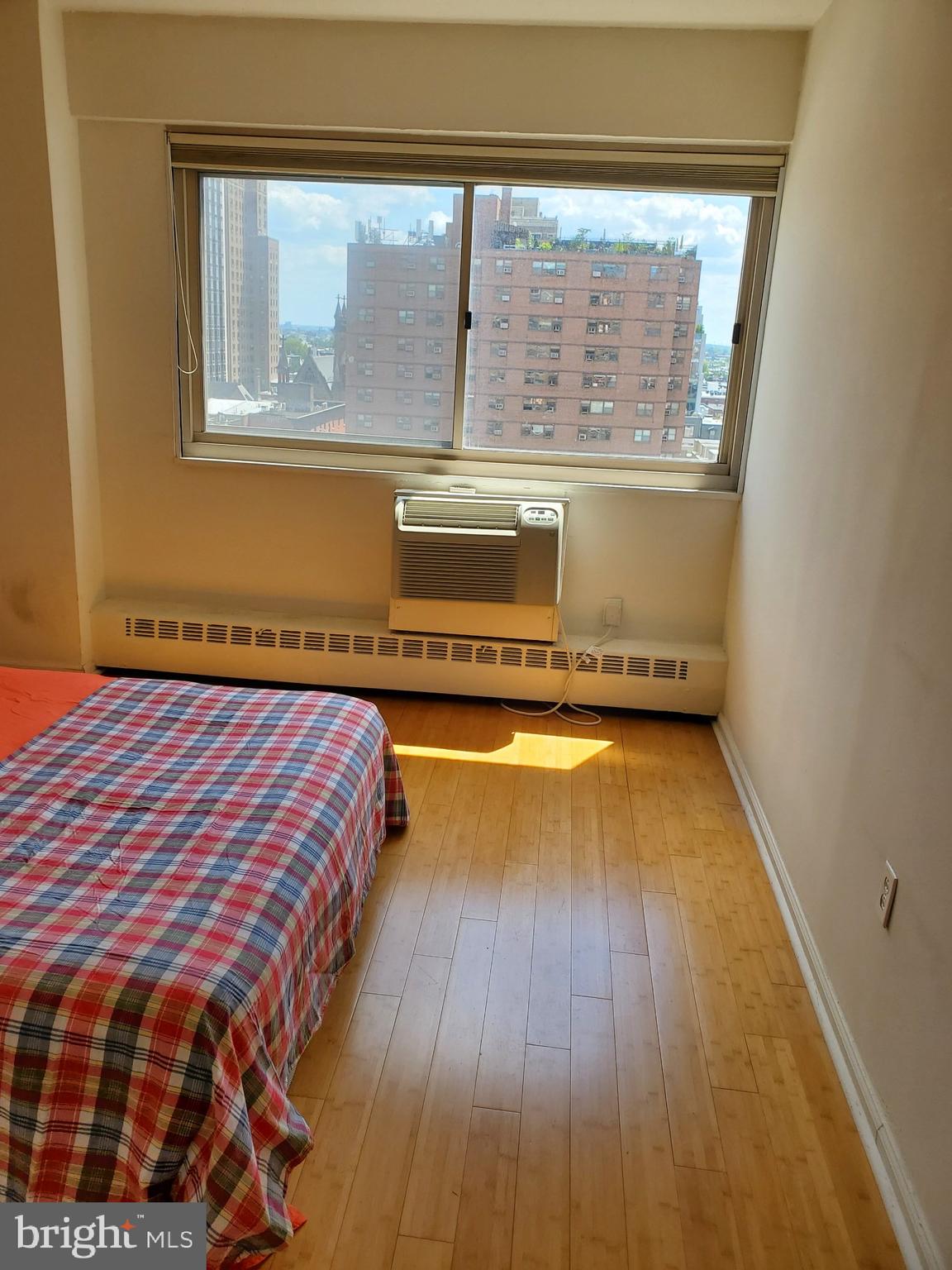 2101-17 Chestnut Street, Unit 1211 Philadelphia, PA 19103 - Photo 8 of 12 a spacious bedroom with a bed and wooden floor