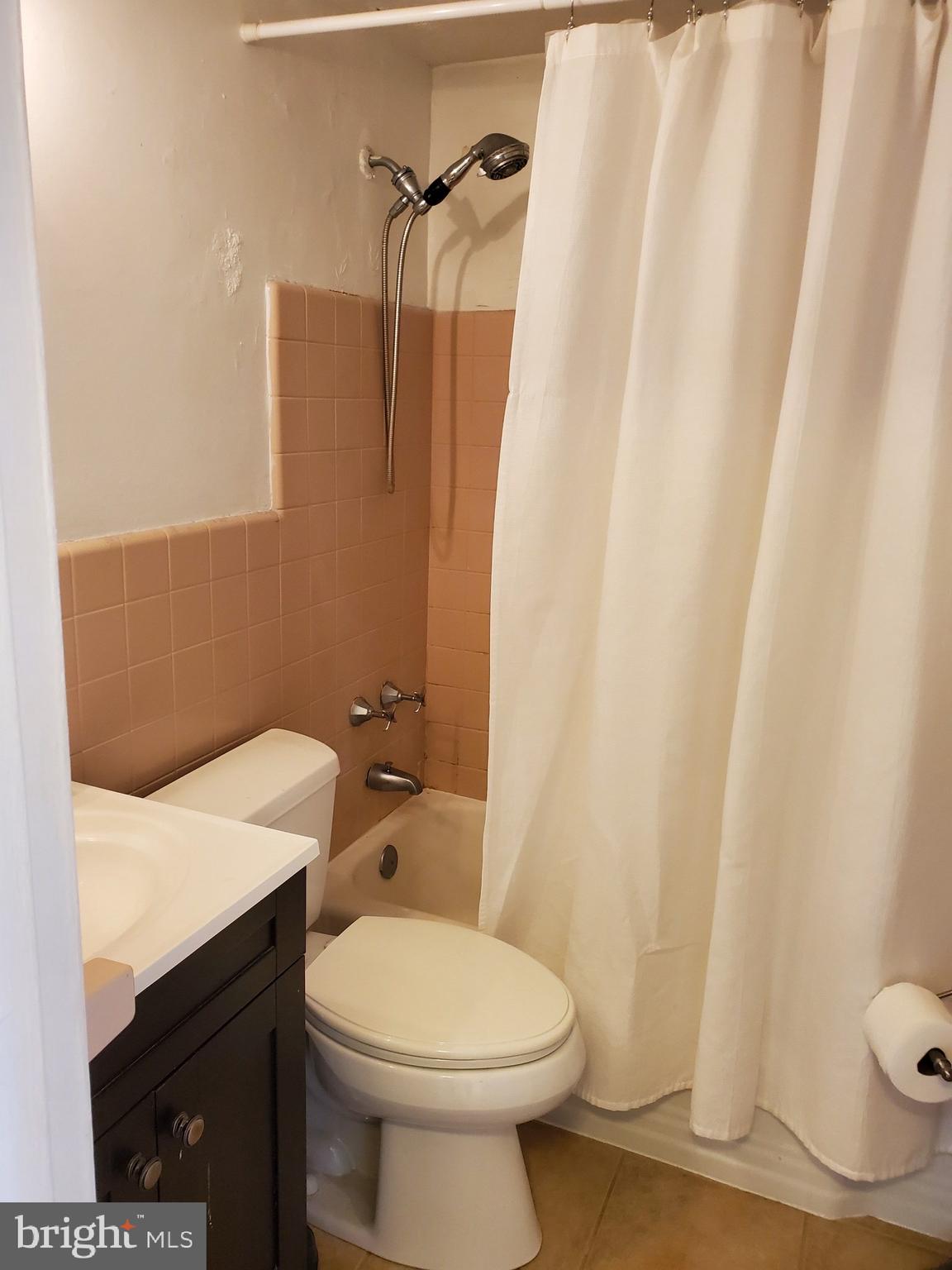 2101-17 Chestnut Street, Unit 1211 Philadelphia, PA 19103 - Photo 10 of 12 a white toilet sitting next to a shower curtain