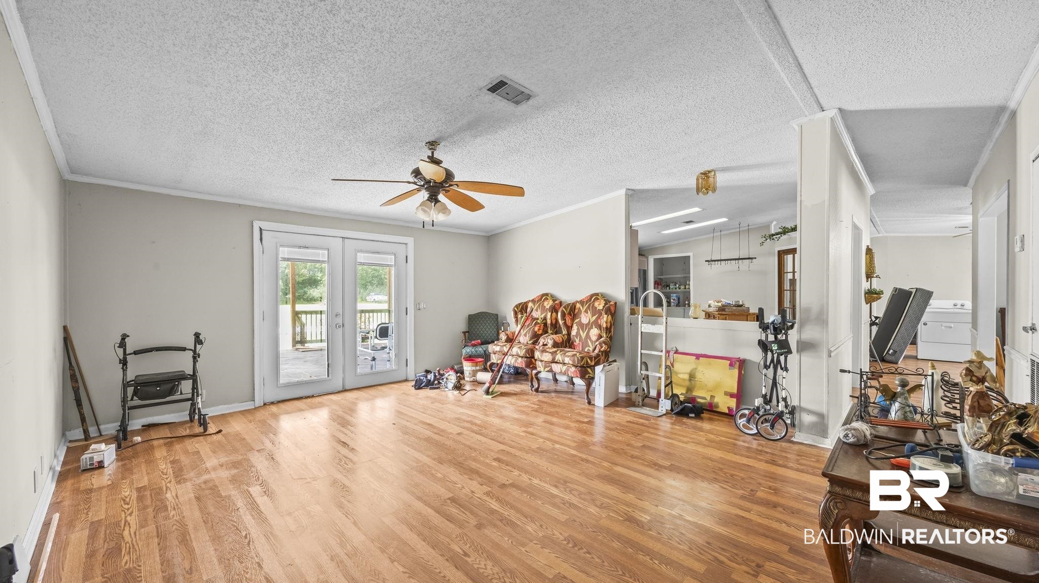 34985b Spring Road South, Unit B Stapleton, AL 36578 - Photo 8 of 31 Spacious interior featuring wood-finish flooring, a ceiling fan, and double glass-paneled doors opening to an outdoor area