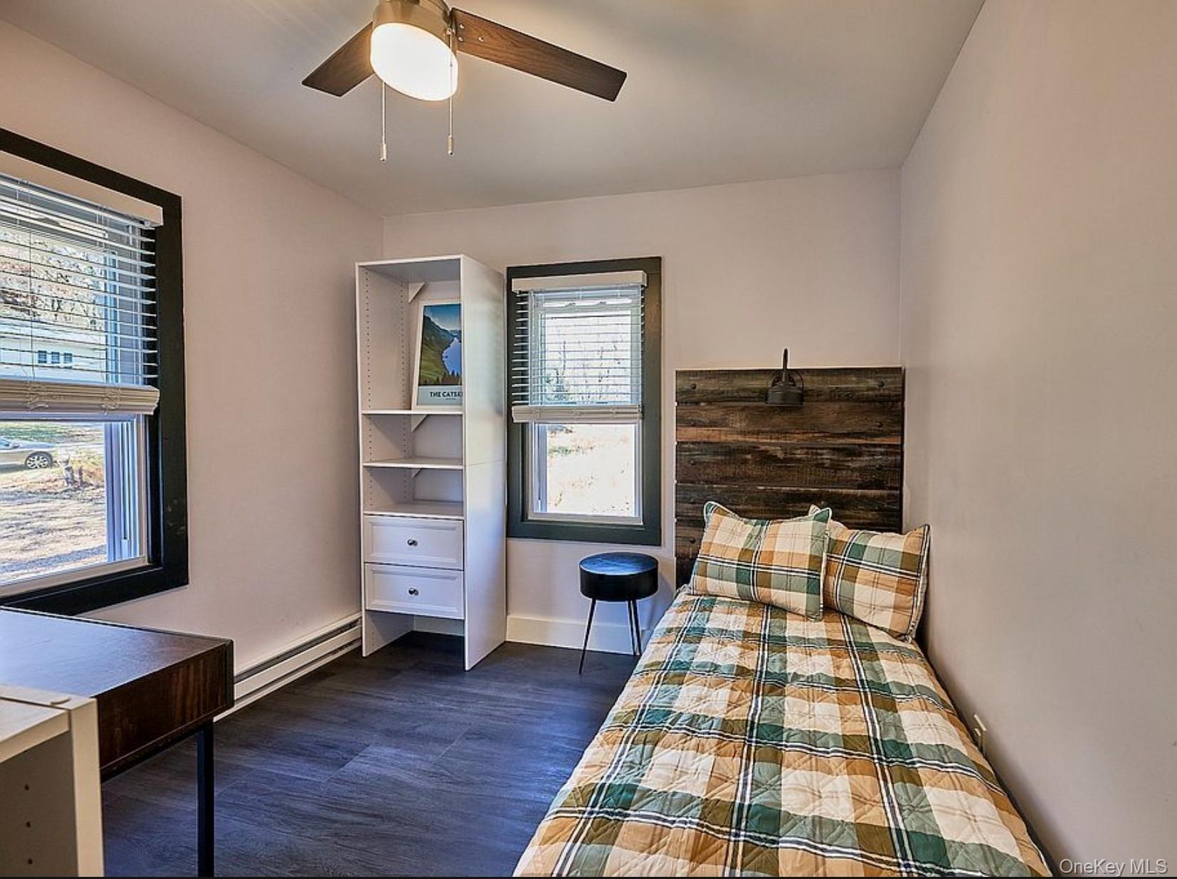 541 Cold Spring Road Monticello, NY 12701 - Photo 27 of 31 a bedroom with a bed and wooden floor