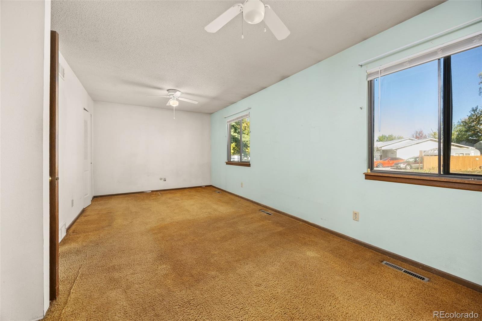1006 Shortline Drive Fort Lupton, CO 80621 - Photo 12 of 33 an empty room with windows and closet