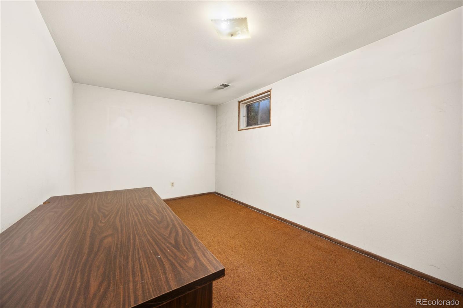 1006 Shortline Drive Fort Lupton, CO 80621 - Photo 20 of 33 a view of a room with wooden floor