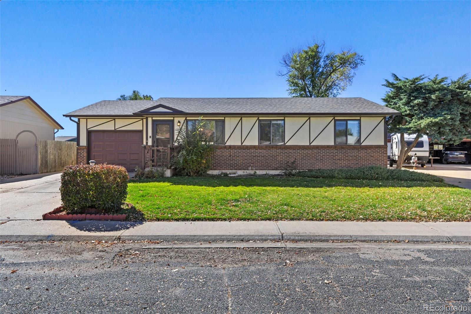 1006 Shortline Drive Fort Lupton, CO 80621 - Photo 2 of 33 a front view of a house with a garden and plants