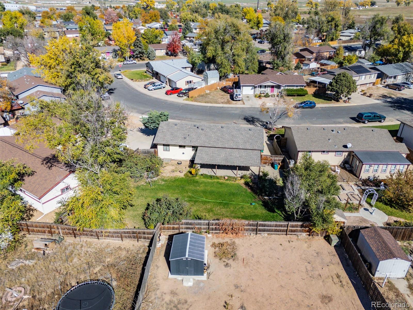 1006 Shortline Drive Fort Lupton, CO 80621 - Photo 28 of 33 an aerial view of a house with a yard basket ball court and outdoor seating