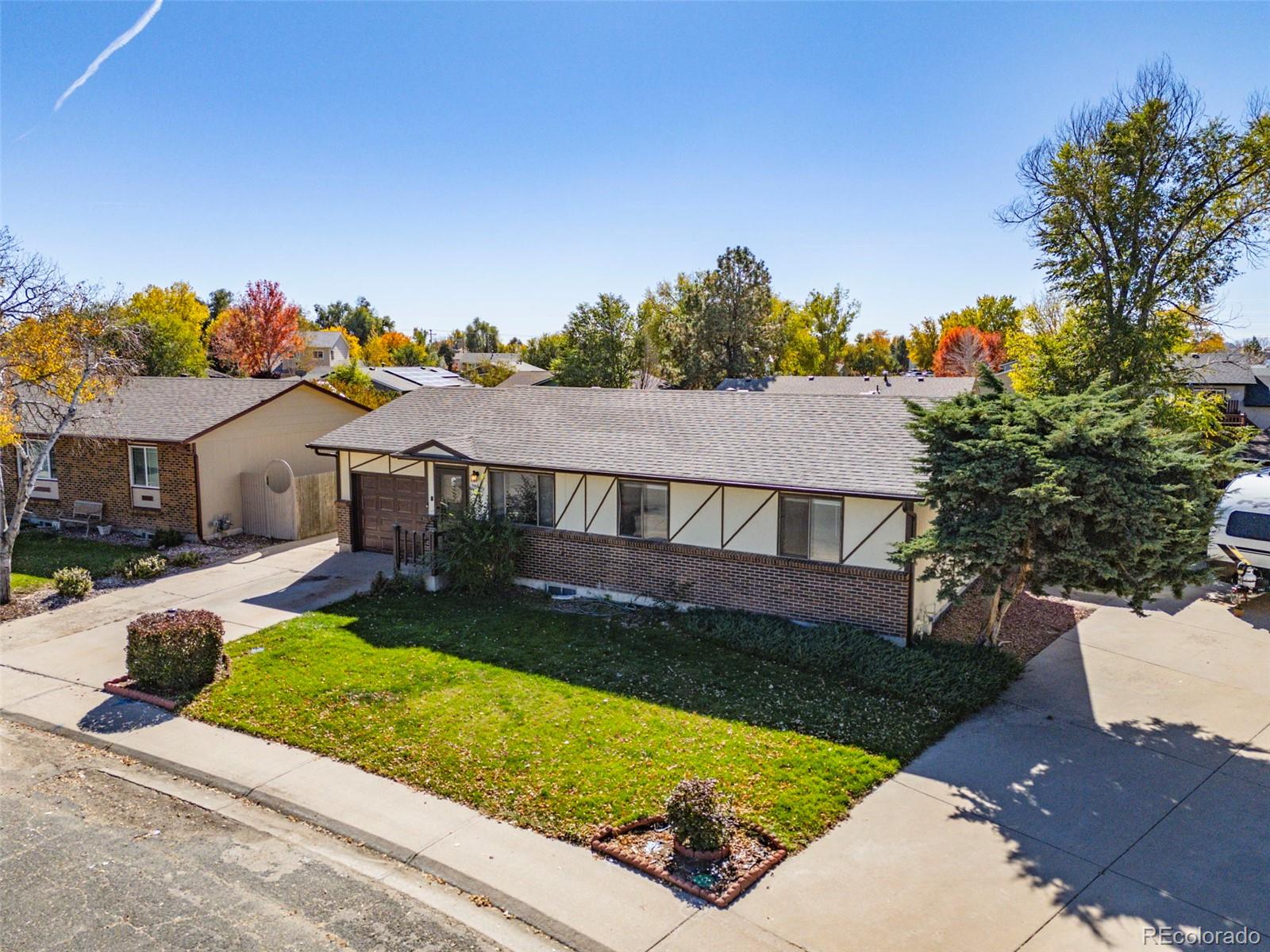 1006 Shortline Drive Fort Lupton, CO 80621 - Photo 4 of 33 a view of house with garden space and sitting area