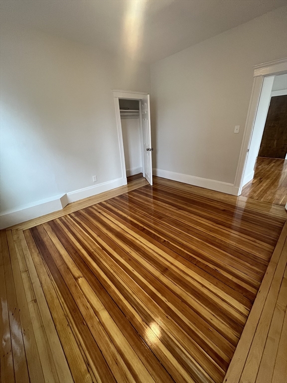 108 Bristol Road, Unit 1 Somerville, MA 02144 - Photo 18 of 24 a view of an empty room and wooden floor