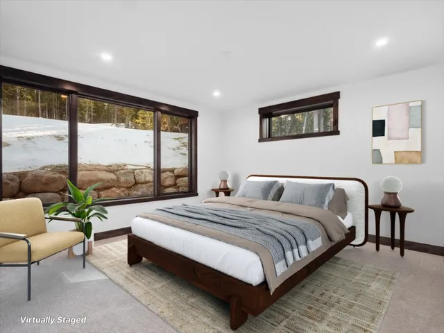 a spacious bedroom with a bed and a large window