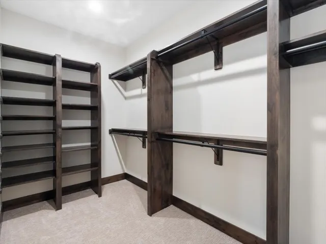 a view of walk in closet with empty racks