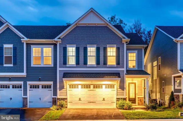 a kitchen with stainless steel appliances granite countertop a stove a sink dishwasher and a refrigerator with wooden floor