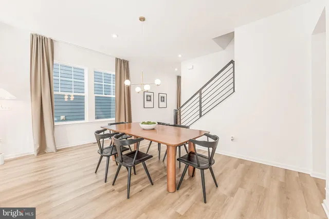a bedroom with a bed a mirror and a large window