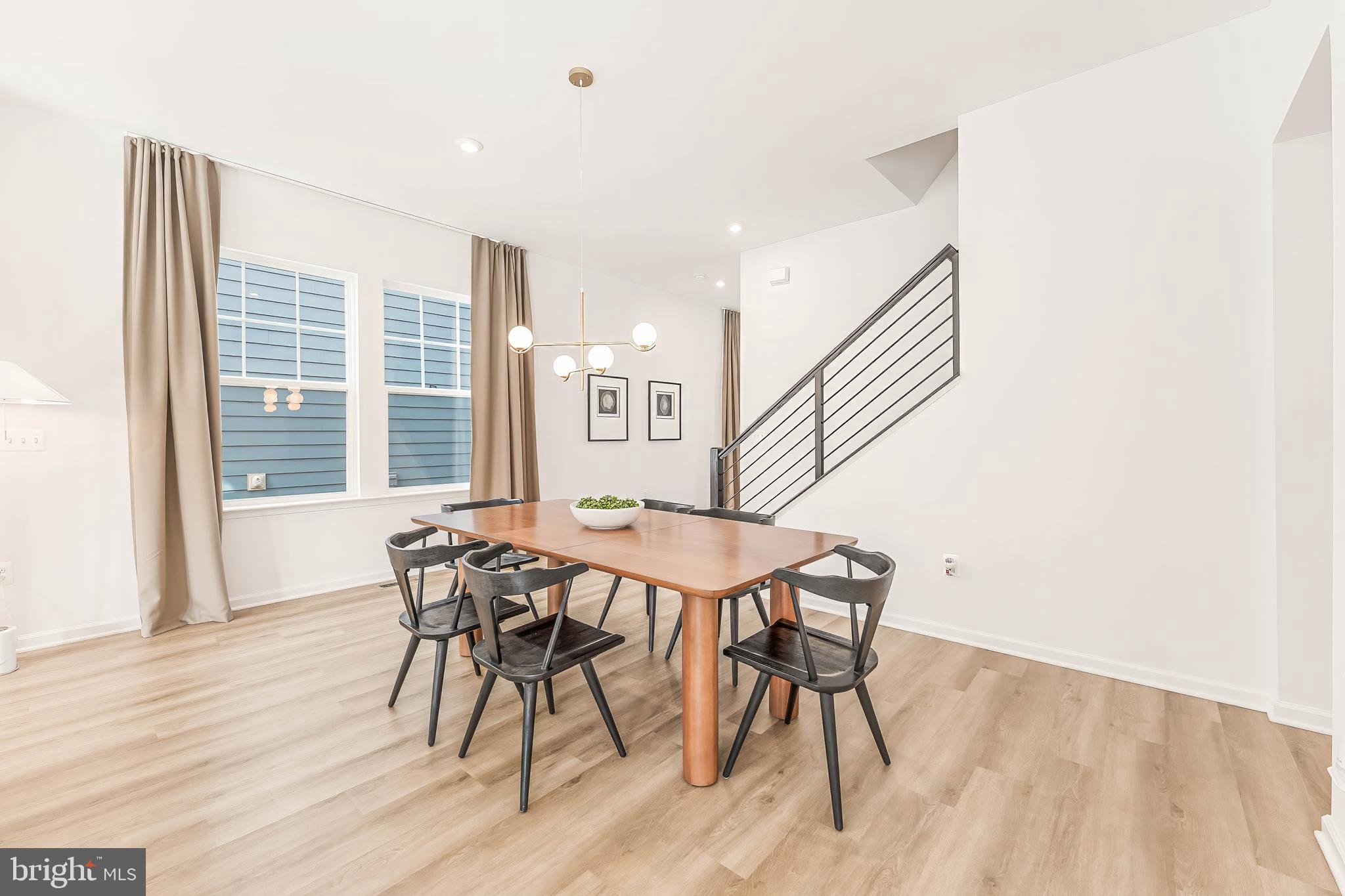 18260 Moss Garden Road Dumfries, VA 22026 - Photo 14 of 97 a view of a dining room with furniture and wooden floor