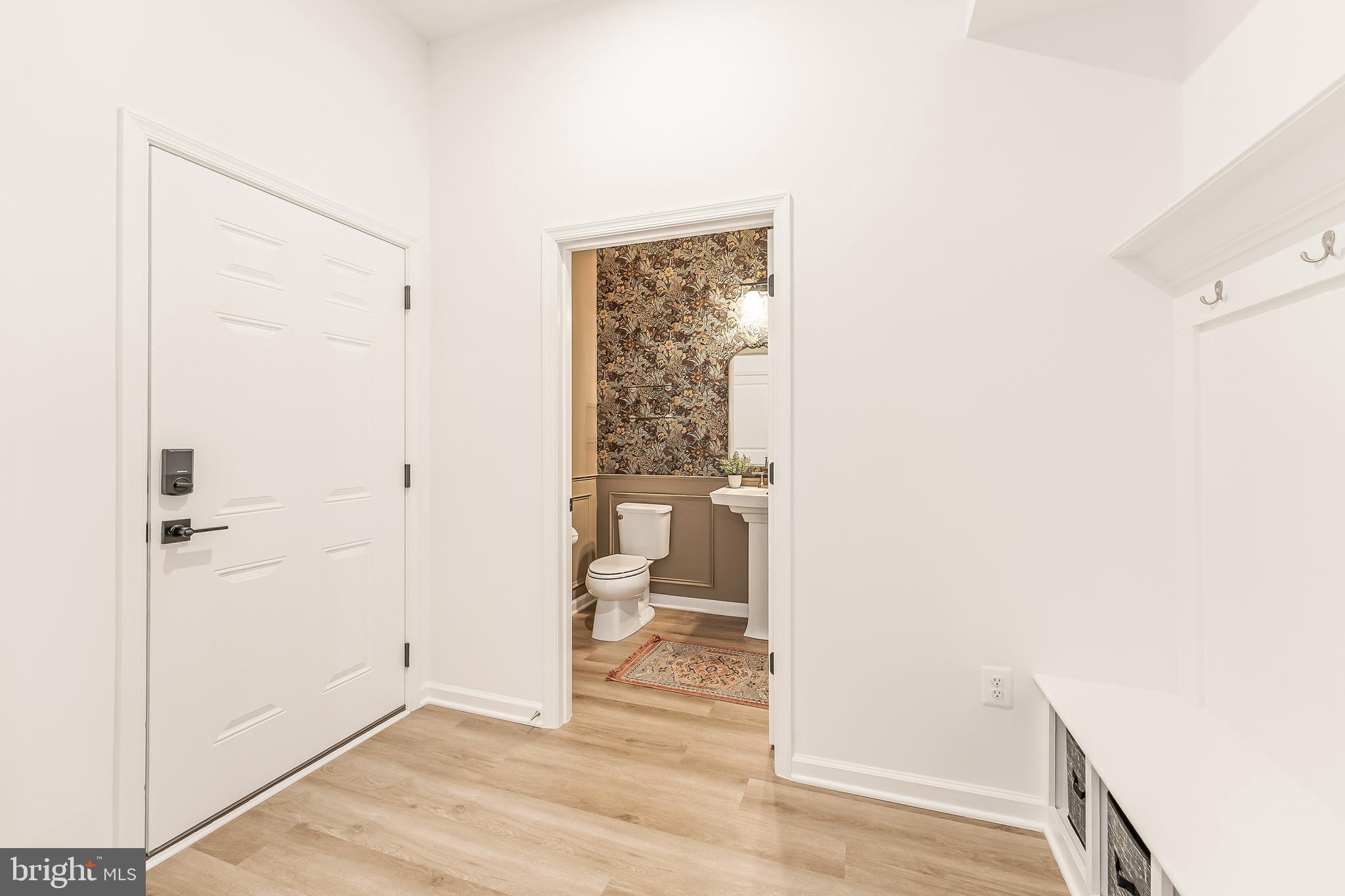 18260 Moss Garden Road Dumfries, VA 22026 - Photo 19 of 97 a view of a hallway with wooden floor and a bathroom