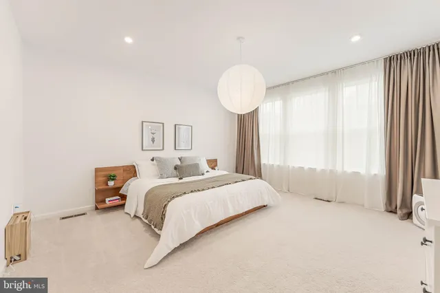 a bedroom with a bed and a night stand