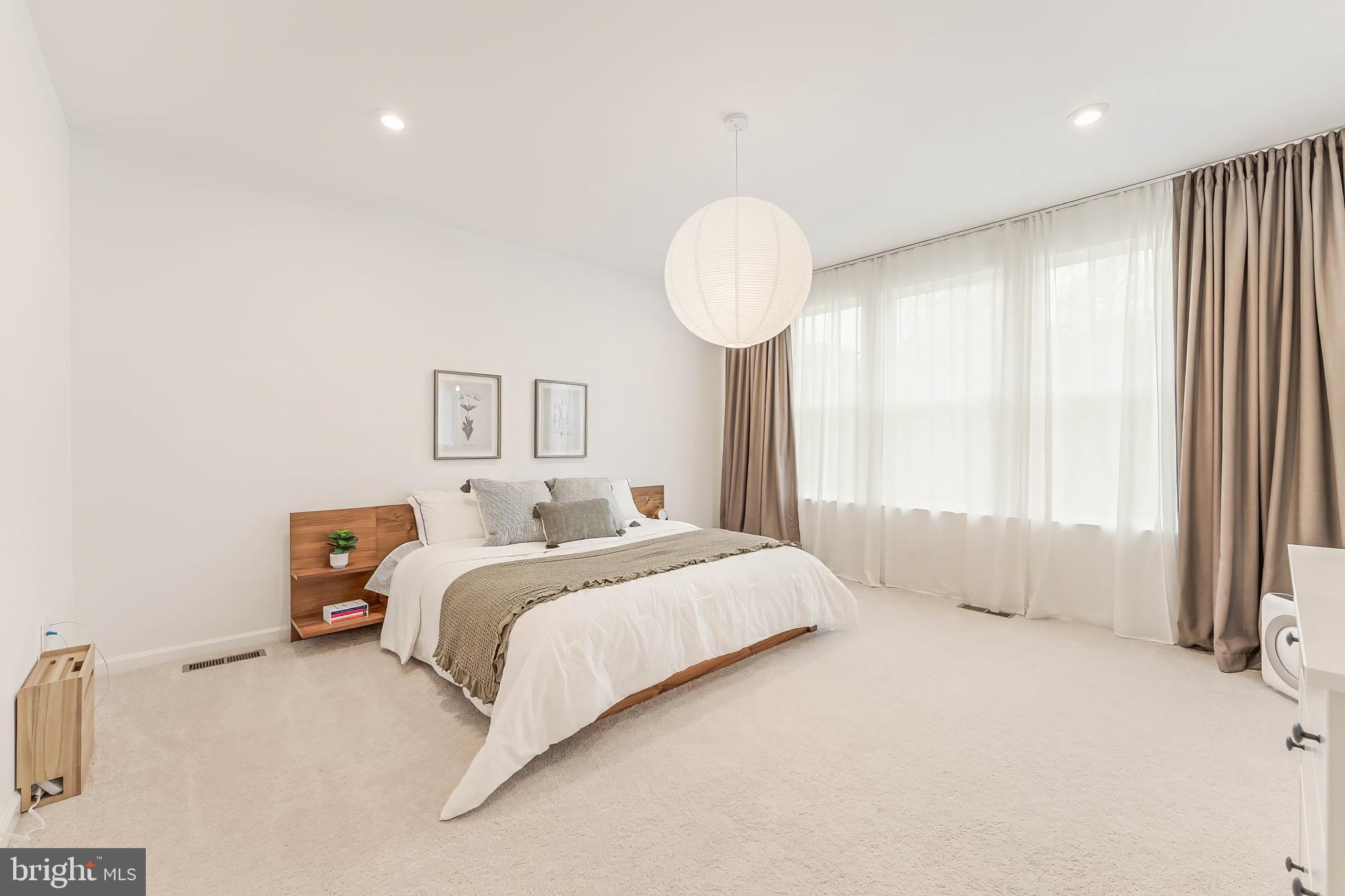 18260 Moss Garden Road Dumfries, VA 22026 - Photo 23 of 97 a spacious bedroom with a bed and a large window
