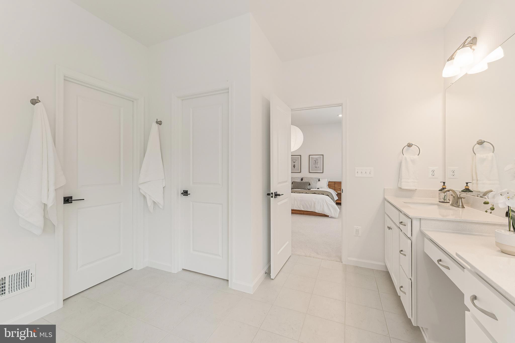 18260 Moss Garden Road Dumfries, VA 22026 - Photo 33 of 97 a en suite bathroom with a double vanity sink a mirror and a shower