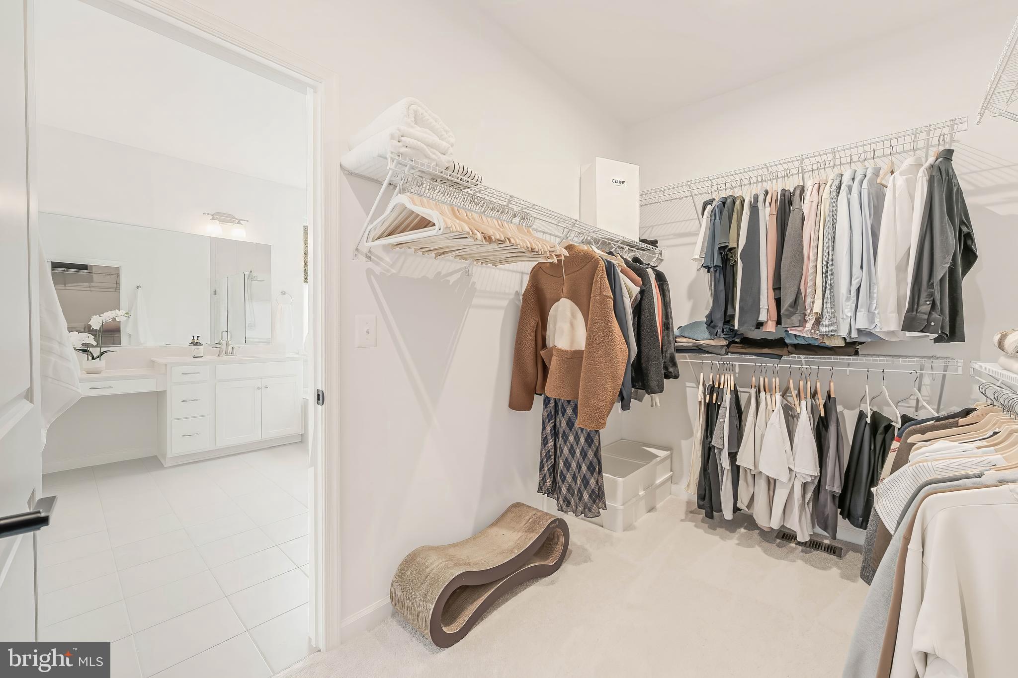 18260 Moss Garden Road Dumfries, VA 22026 - Photo 34 of 97 a view of walk in closet with clothes and shoes