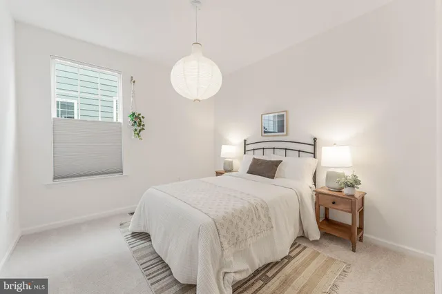 a bedroom with a bed and a lamp