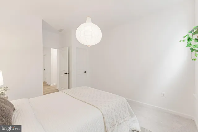 a living room with furniture and a lamp