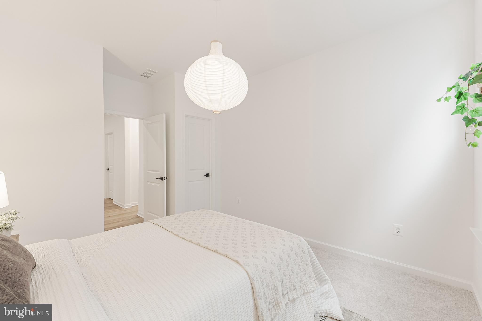 18260 Moss Garden Road Dumfries, VA 22026 - Photo 38 of 97 a bedroom with a bed and a potted plant