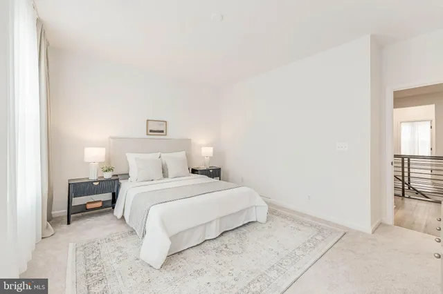 a bedroom with a white bed and a white cabinet
