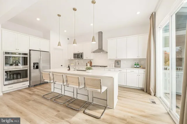 a living room with fireplace furniture and a large window